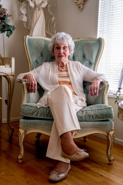 istock 100-Year Old Woman Having a Cheerful Conversation in Her Home 1144576250