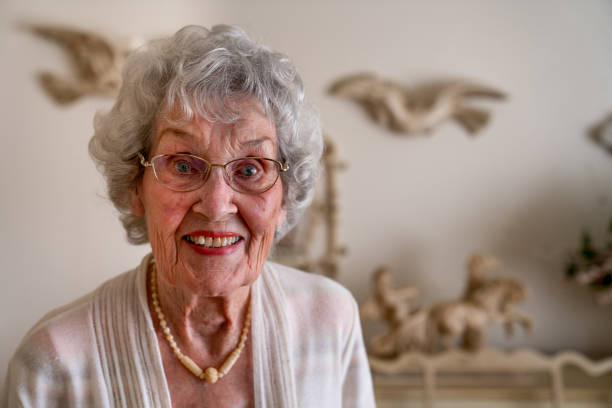 istock 100-Year Old Woman Having a Cheerful Conversation in Her Home 1144576329