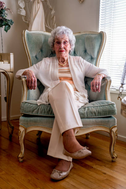 istock 100-Year Old Woman Having a Cheerful Conversation in Her Home 1144576909