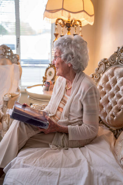 istock 100-Year Old Woman Having a Cheerful Conversation in Her Home 1144577030
