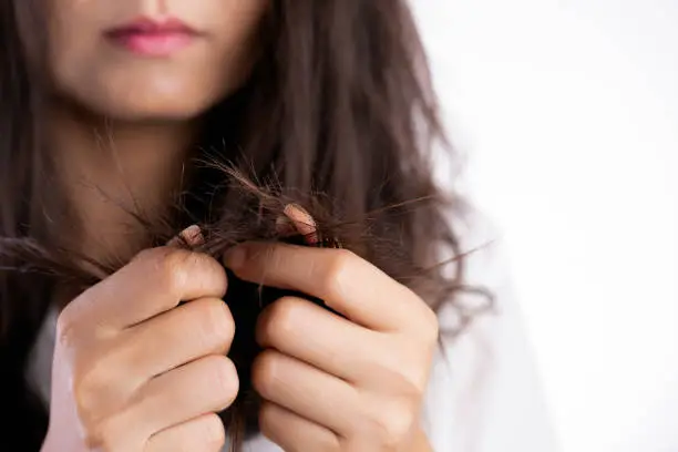 Photo of Healthy concept. Woman hand holding damaged long hair.