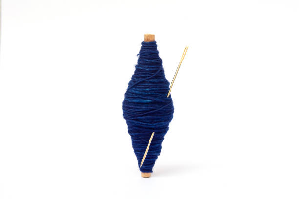 expertse craftmanship indigo dye blue color handmade natural line of cotton thread wrap on small wooden core with white background