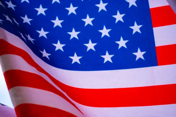 Wavy of United Stated of America flag with white background.-Image.