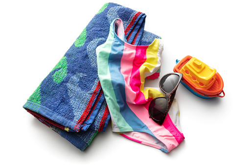 Summer: Towel, Swimsuit, Sunglasses and Toy Boat Isolated on White Background