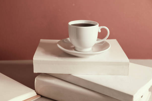 istock Cup of coffee over a stack of closed books 1144580747