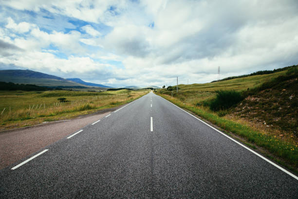 istock Trip or adventure: Abandoned, dramatic road in Scotland, cloudy sky. 1144581392