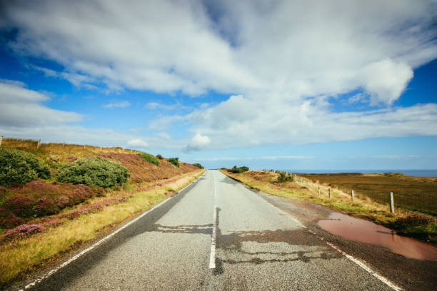 istock Trip or adventure: Abandoned, dramatic road in Scotland, cloudy sky. 1144581439
