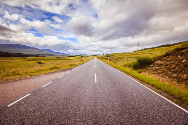 istock Trip or adventure: Abandoned, dramatic road in Scotland, cloudy sky. 1144581440