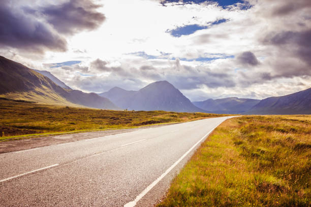 istock Trip or adventure: Abandoned, dramatic road in Scotland, cloudy sky. 1144581458