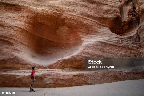 Asian Man Traveler And Photographer Standing In The Siq The Narrow Slotcanyon That Serves As The Entrance Passage To The Hidden City Of Petra Jordan Travel Middle East Concept Stock Photo - Download Image Now