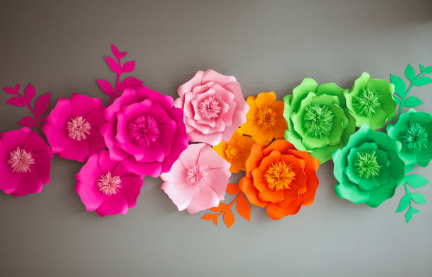 istock Colorful paper flowers on gray wall 1144582501