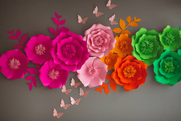 istock Colorful paper flowers on gray wall 1144582527