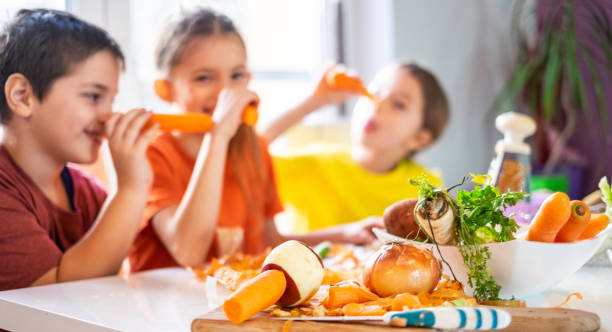 istock Children are playing with carrots. 1144582594