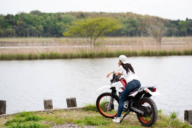 istock Woman parked a motorcycle by the lake 1144585002