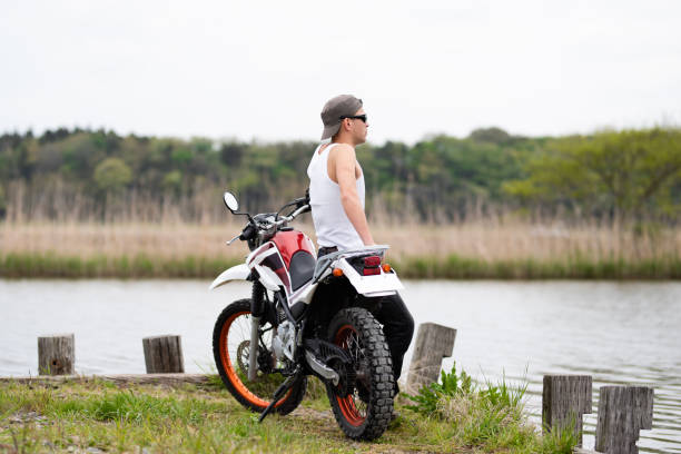 A man parked a motorcycle by the lake
