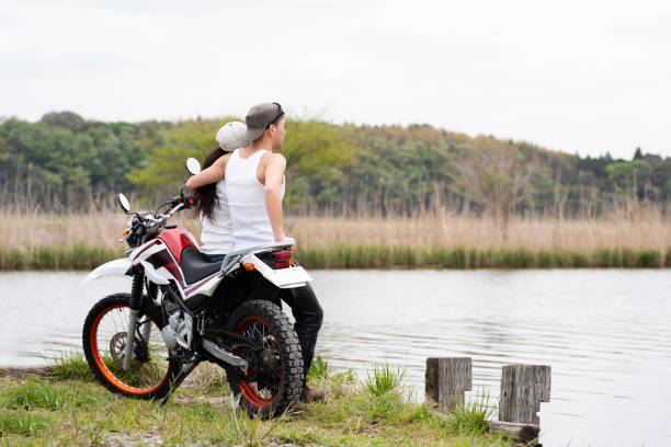istock couple parked a motorcycle by the lake 1144585060
