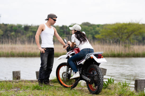 istock couple parked a motorcycle by the lake 1144585124