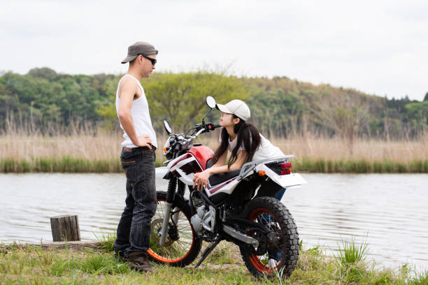 istock couple parked a motorcycle by the lake 1144585129