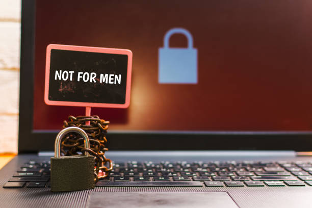 istock plate with text NOT FOR MEN with padlock and chain on keyboard laptop 1144585190