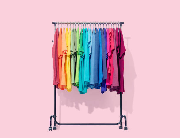 istock Mobile rack with color clothes on light pink background. File contains a path to isolation. 1144587408