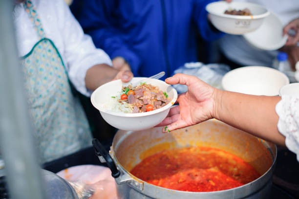 istock Social Problems of Poverty Helped by Feeding : Concepts problems of life the poor : Volunteers Share Food to the Poor to Relieve Hunger 1144587708