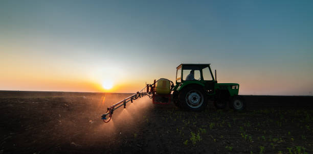istock Tractor spraying pesticides at  soy bean fields 1144591708