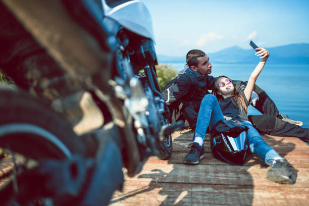 Cute Biker Couple Taking Selfie On Pier