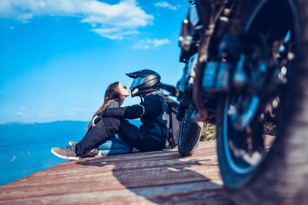 istock Motorcyclist Couple Kissing Goodbye 1144592018