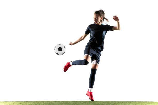 istock Female soccer player kicking ball isolated over white background 1144592995