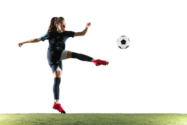 istock Female soccer player kicking ball isolated over white background 1144593006
