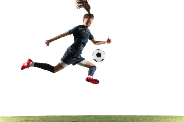 istock Female soccer player kicking ball isolated over white background 1144593021