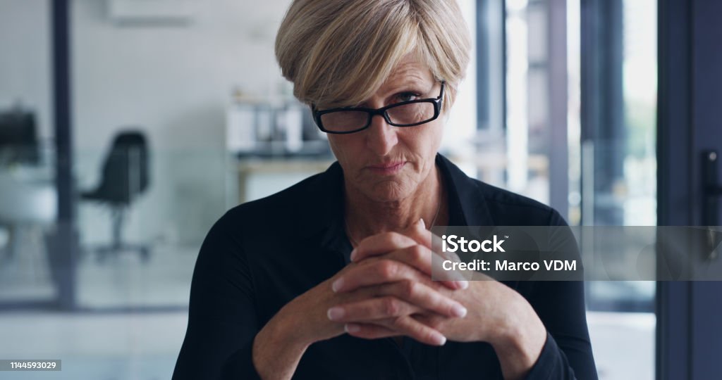 There's no place for mediocre in this business Portrait of a mature businesswoman in an office Judgement Stock Photo