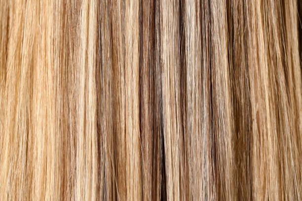 istock Woman hair dyeing in salon closeup pattern 1144593415