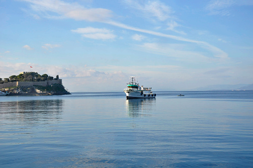 white clouds under a boat on blue sea