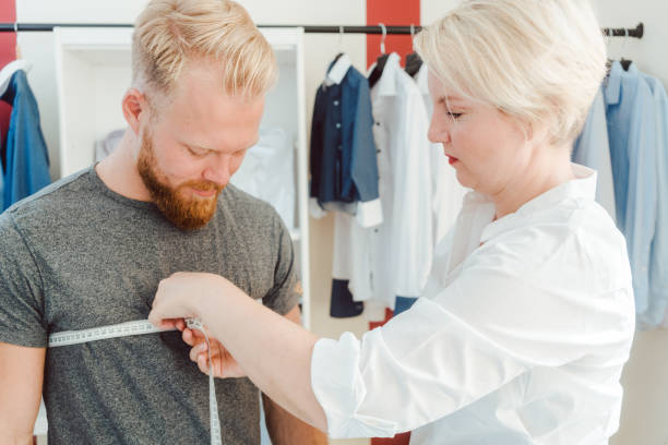istock Tailor measuring customer with measuring tape 1144602152