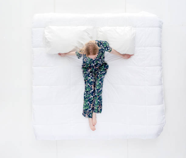 istock Single female sitting in bed 1144602278