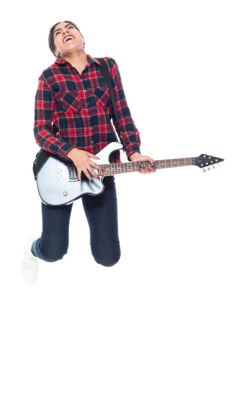 istock Beautiful young latino female playing an electrical guitar 1144602458