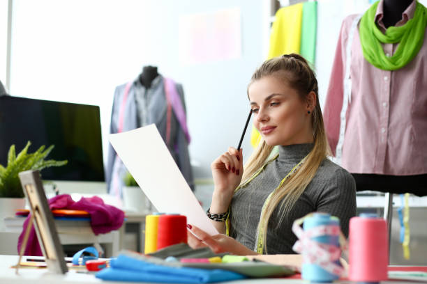 Female fashion designer sit at her office