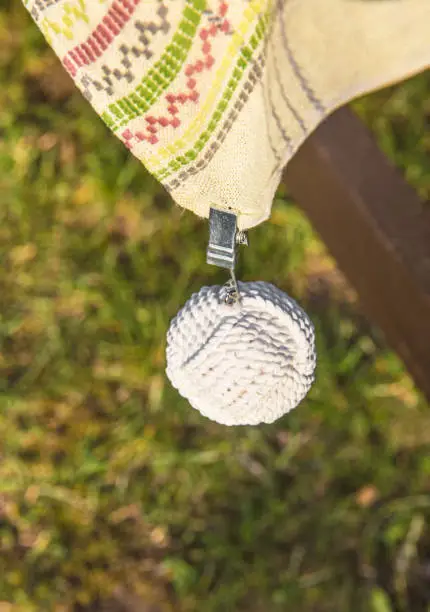 Photo of Clip tablecloth weights attached to a table cloth outdoors these are designed to hold your table cloth steady on windy day when you want to eat outside.