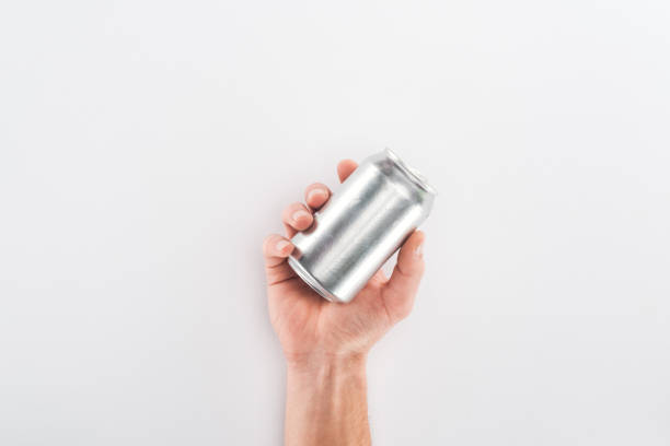 Cropped view of man holding empty can on grey background