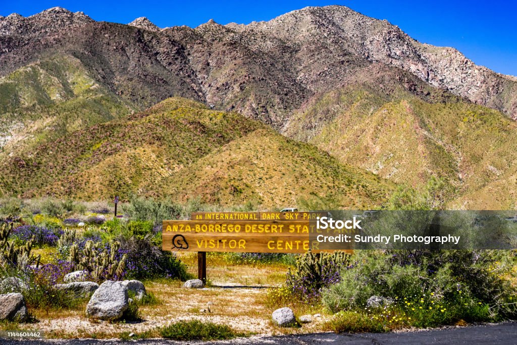 Anza-Borrego Desert State Park Visitor Center sign surrounded by wildflowers during a spring superbloom, south California Anza Borrego Desert State Park Stock Photo