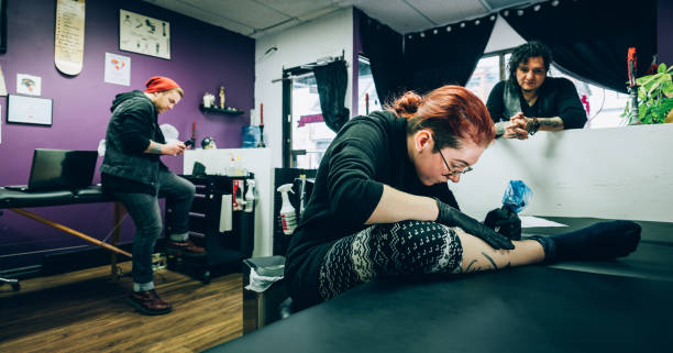 istock Tattoo artist appretice at work 1144607173