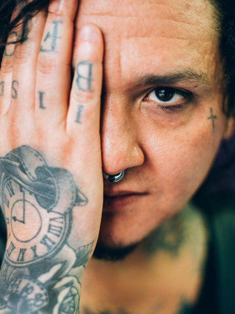 Portrait of the male tattoo artist drawing in his studio.