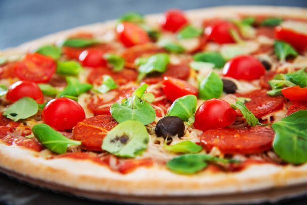 istock Sausage Pizza with Ham and tomatoes 1144608064