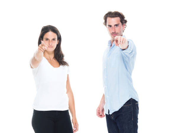 istock Attractive couple are pointing towards camera 1144608219