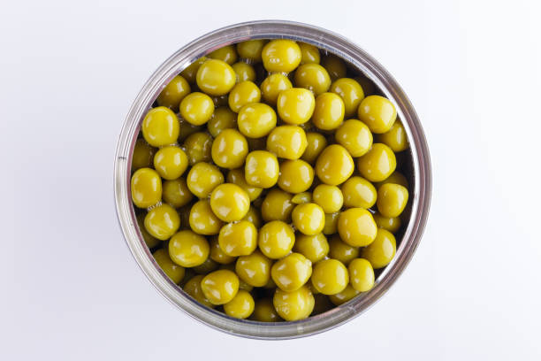 istock Canned green peas in a iron can on white background 1144609160