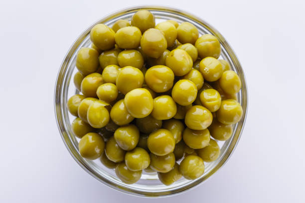 istock canned green peas in a glass bowl on a white background 1144609237