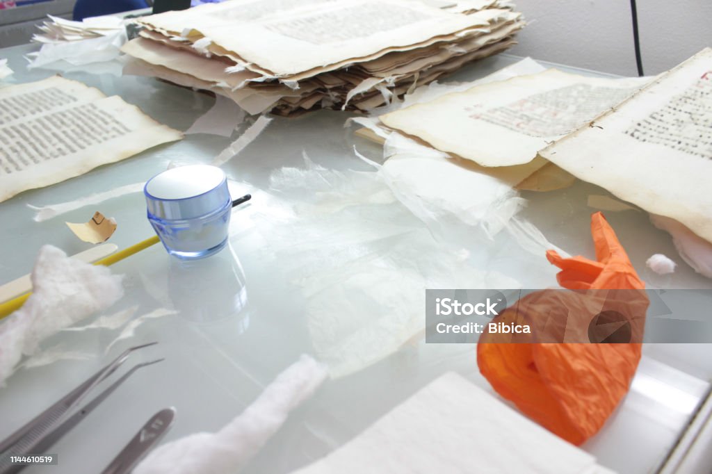 Paper of an old book on restauration Paper of an old book on restauration on glass light table in conservation laboratory 2019 Stock Photo
