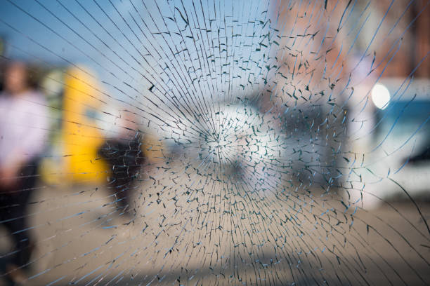 istock Cracked glass texture on a city background. 1144611233