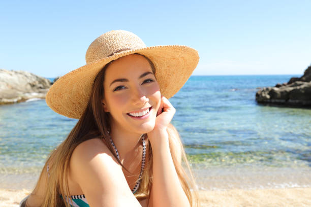 istock Candid tourist on the beach looking at camera 1144612083